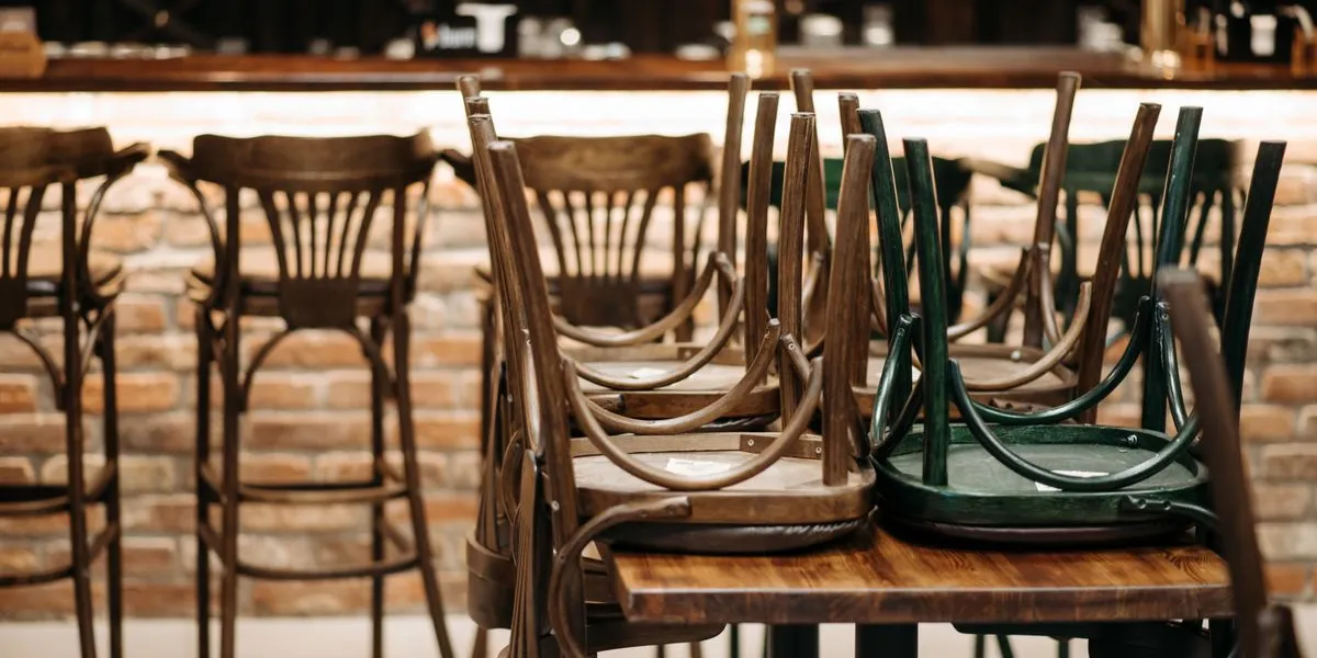 Chairs stacked on tables in a closed restaurant — decorative stock image