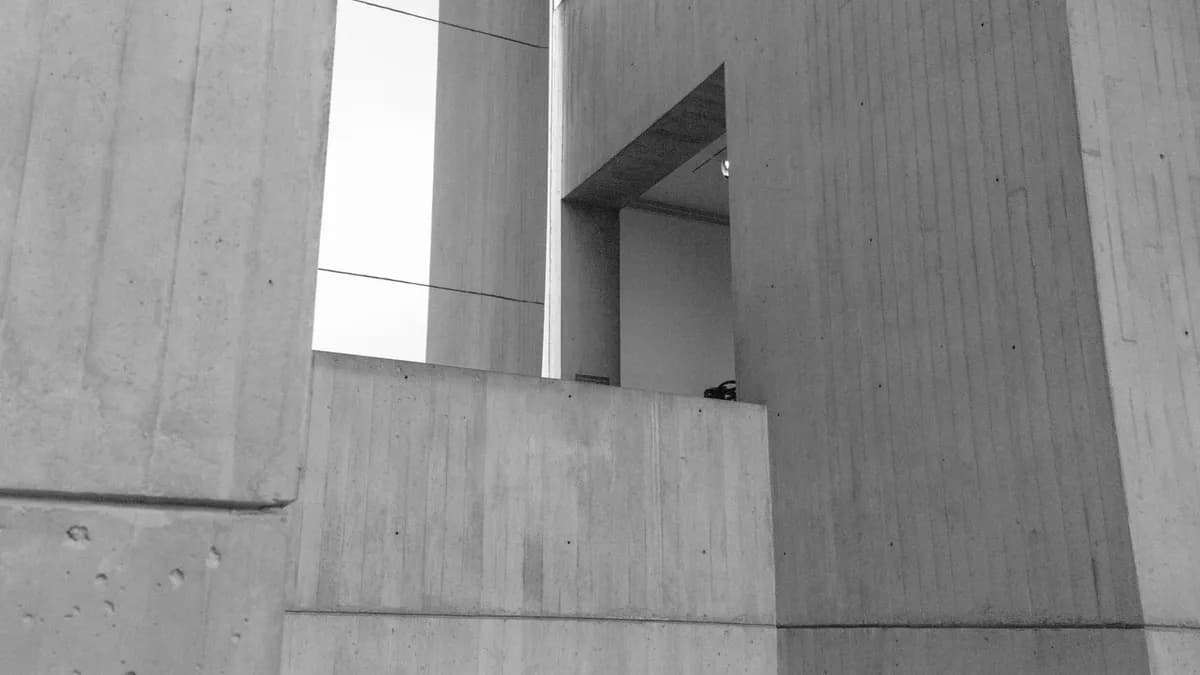 Explore the abstract beauty of minimalist concrete structures captured in striking black and white.