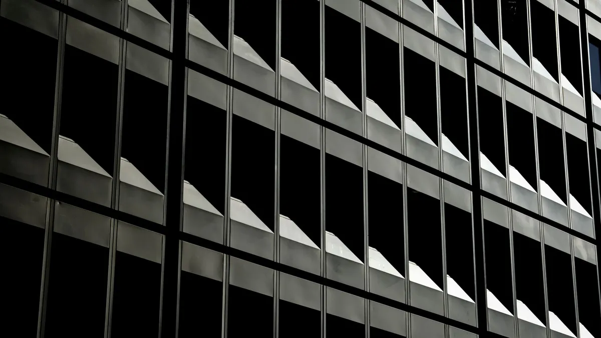 Abstract view of an urban office building's repetitive window patterns, capturing modern architecture.