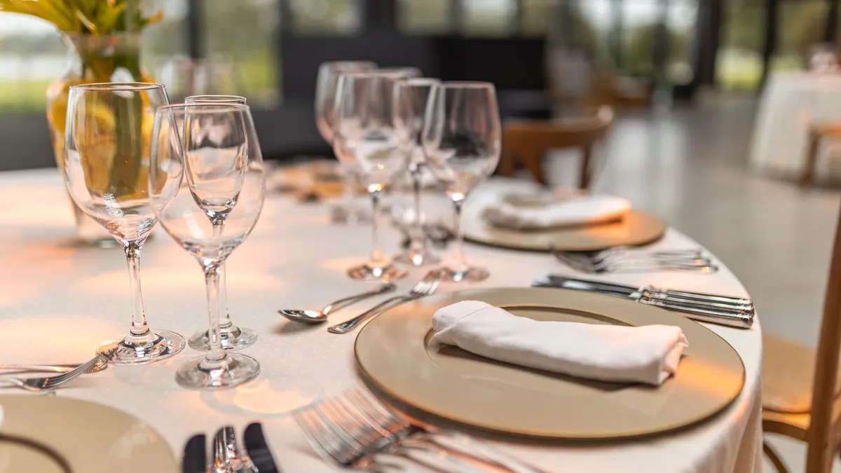 Sophisticated table setup with glassware and napkins for fine dining experience.