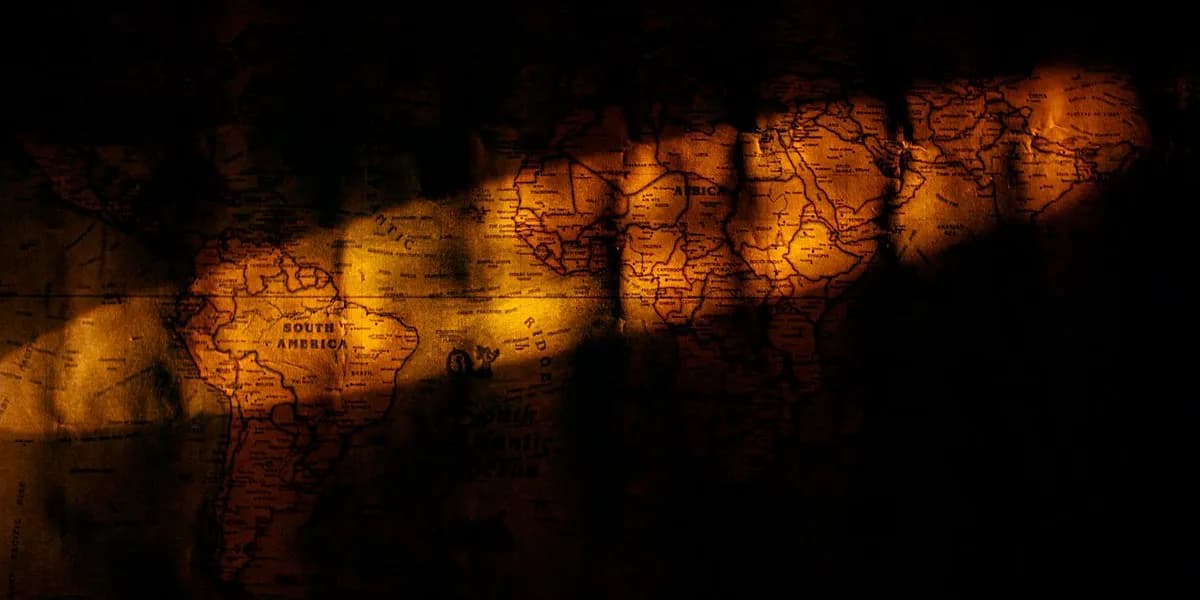 A vintage world map lit by warm light — decorative stock image